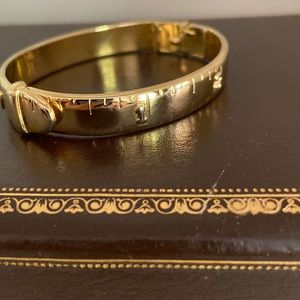 Signed KJL gold plated clamper bracelet of measurement tape. Unique.